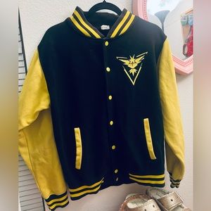 cute lil varsity jacket, black and yellow. apparently a pokemon logo?